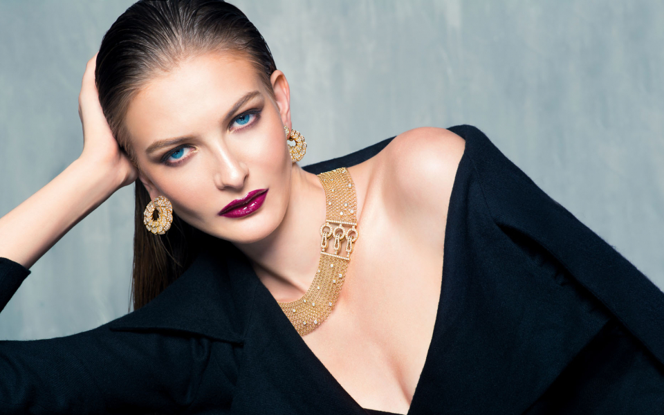 CLASS ACT: Earrings in yellow gold set with diamonds, and a necklace in pink gold set with diamonds, both by Cartier; coat by P’IA