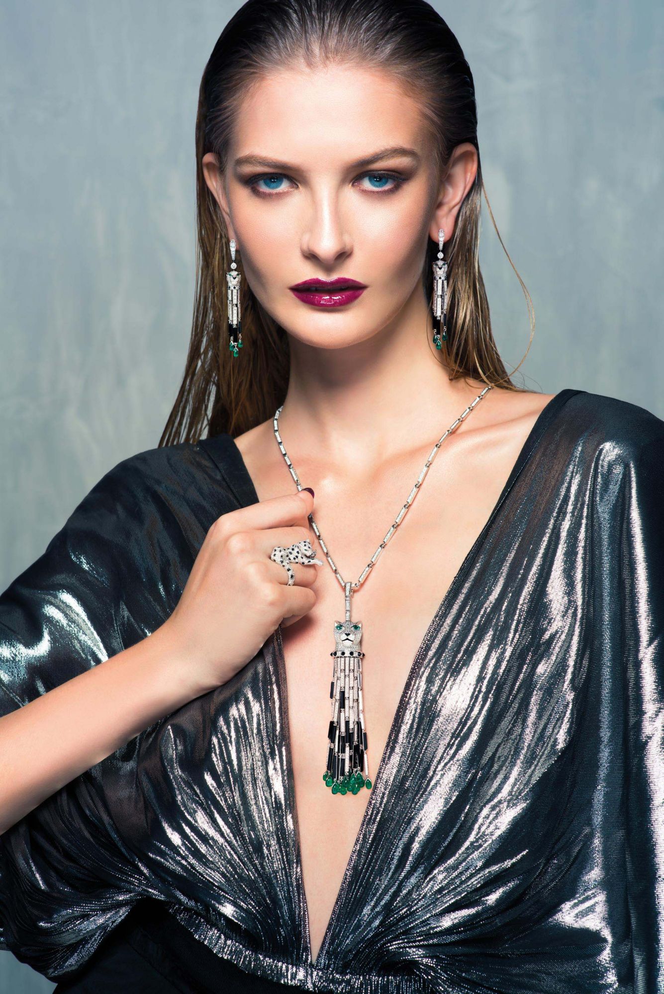 WILD AT HEART: Earrings, ring and necklace in white gold set with diamonds, emeralds and onyx by Cartier; dress by Loewe