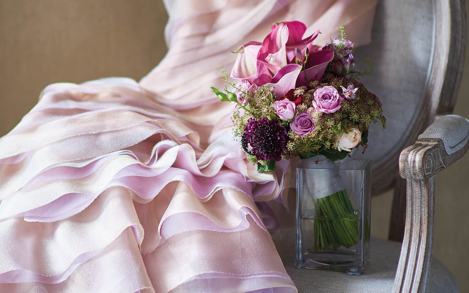 Bouquet of calla lilies, mini roses, clematis and dill by Armani/Fiori; dress by Vivian Luk; chair from Bowerbird Home