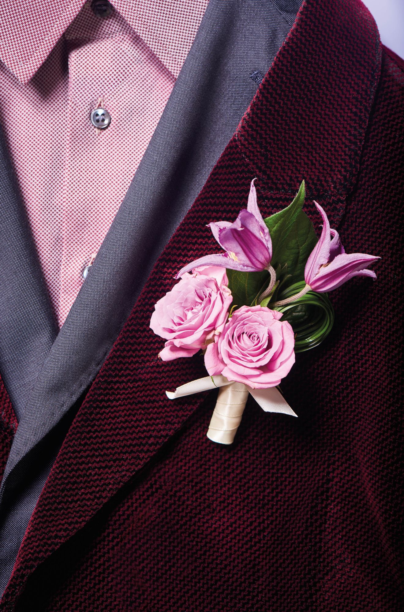 Boutonnière of clematis and roses by Armani/Fiori; shirt and jackets by Giorgio Armani