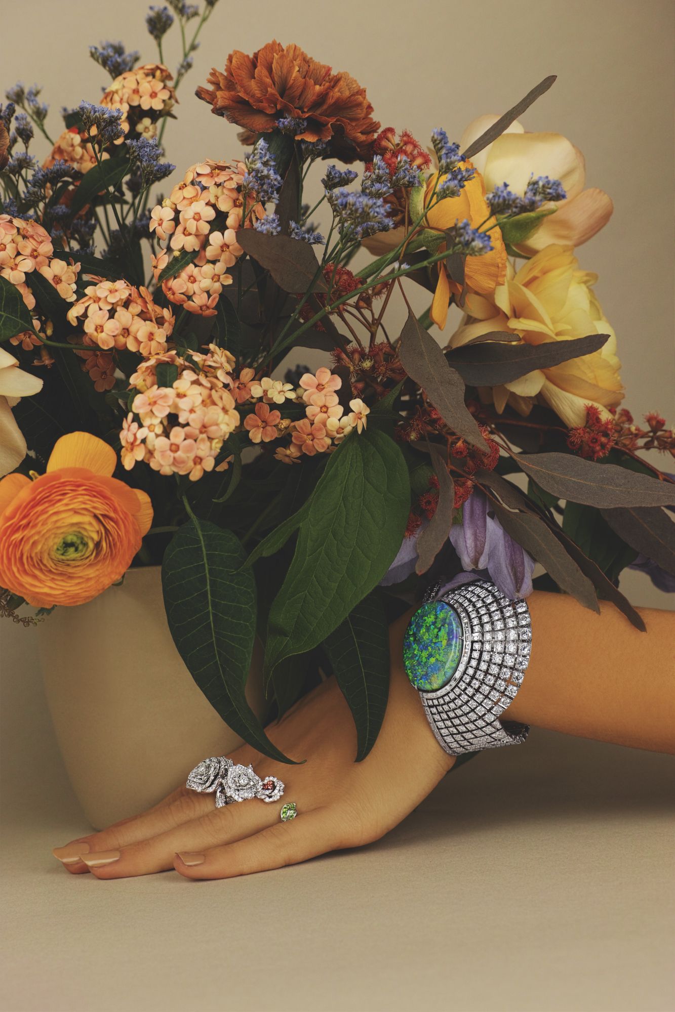 Bagatelle ring in white gold set with diamonds; Bagatelle ring in white and pink gold set with tsavorite garnets and pink sapphires, both from the Rose Dior collection by Dior Joaillerie; Aten high jewellery watch in white gold set with opal and diamonds by Cartier