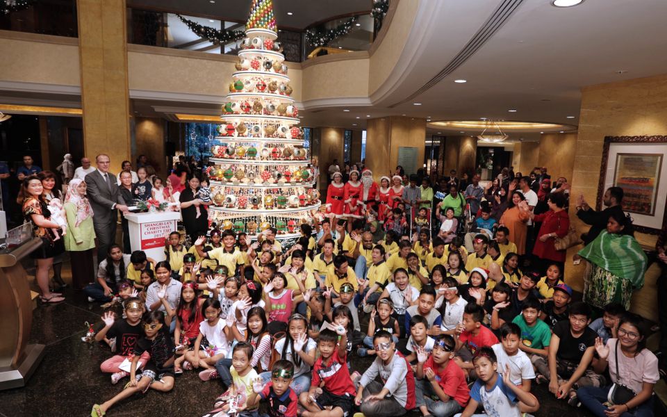 Manfred Weber - standing fourth from left - area general manager of Shangri-La Hotel Kuala Lumpur, lighted up ‘The Glittering Baubles of Life’ Christmas tree