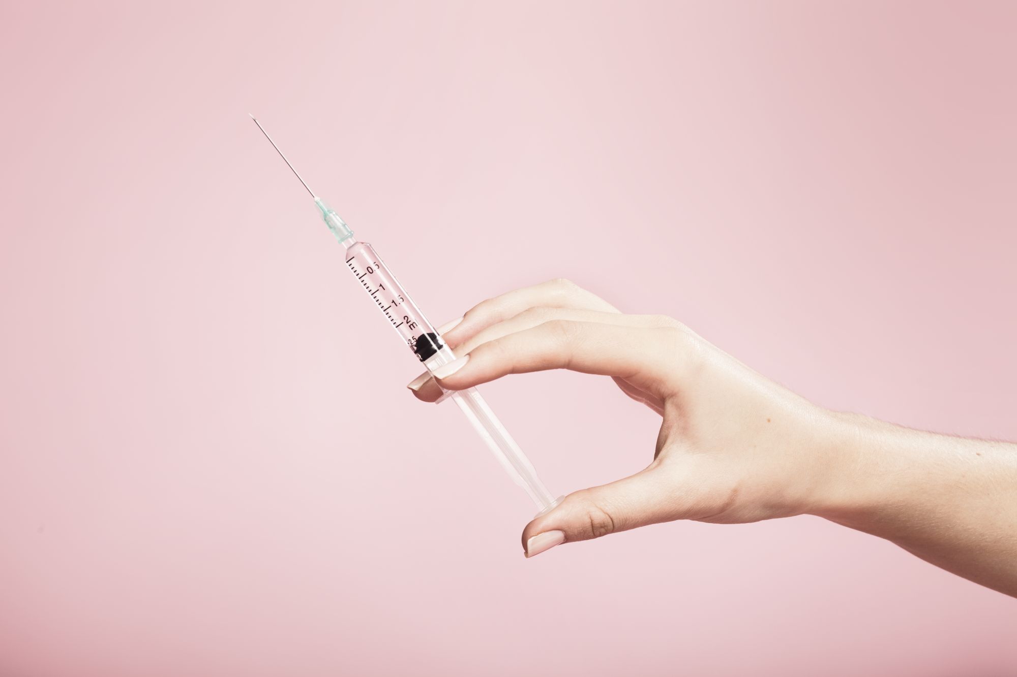 hand, holding, syringe, background, studio, plain, pink, finger, fingers, needle