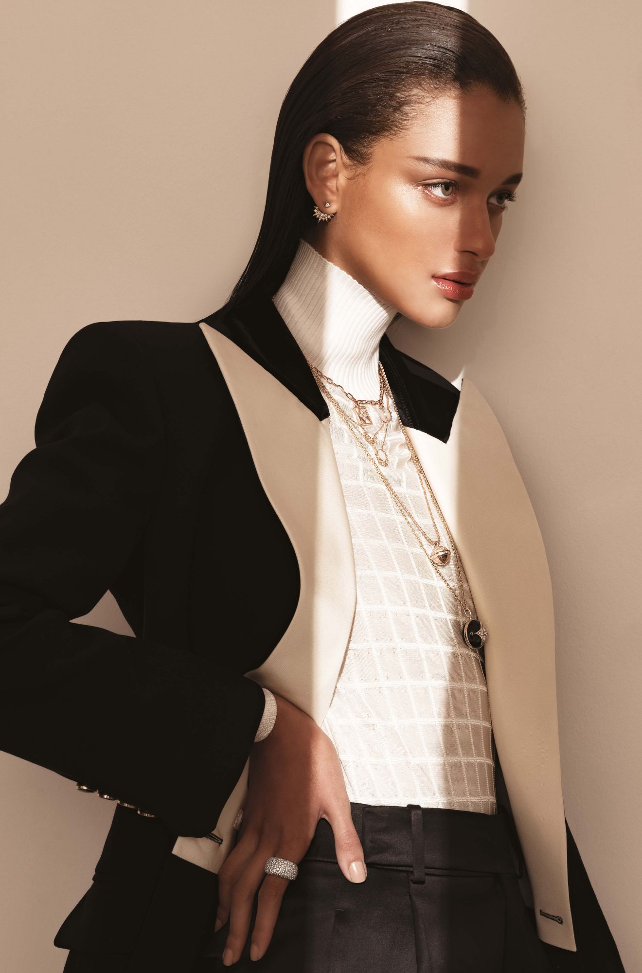 Sunlight ear jacket in rose gold set with diamonds, by Piaget; B Blossom necklace in pink and white gold set with pink opals, mother-of-pearl and diamonds, by Louis Vuitton; Sunlight necklaces in rose gold set with diamonds and white opals, by Piaget; B Blossom necklace in yellow gold set with onyx and diamonds, by Louis Vuitton; Possession necklace in rose gold set with diamonds, by Piaget; Sunlight ring in rose gold set with diamonds, by Piaget; jacket by Gucci; top by Chloé; trousers by Saint Laurent