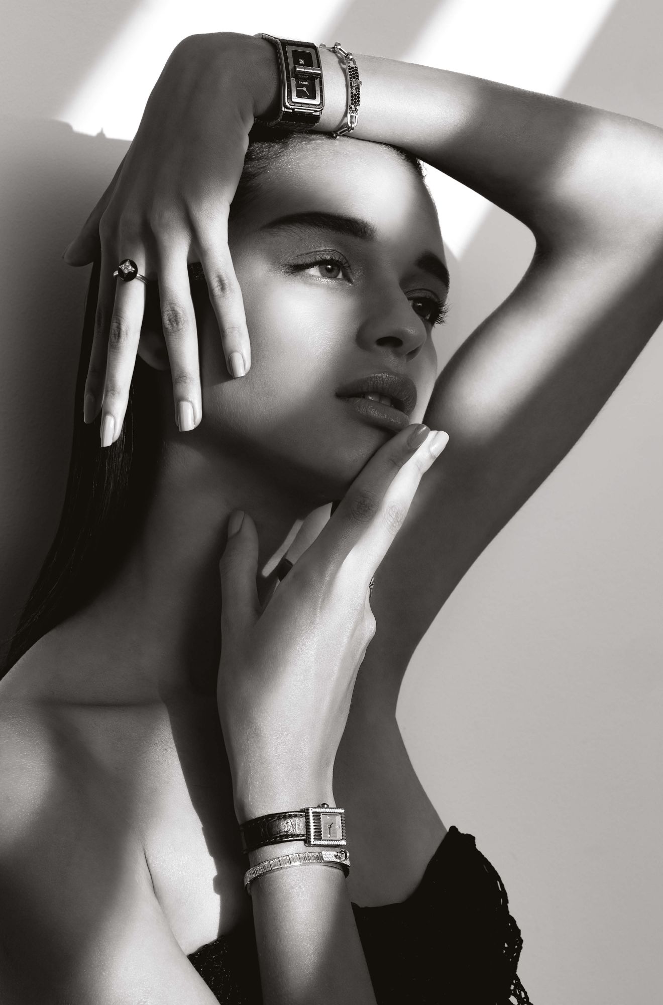 From top: Code Coco watch in steel and ceramic set with diamonds, by Chanel; Kelly Chaine bracelet in rose gold set with black diamonds, by Hermès; B Blossom ring in yellow and white gold set with onyx and diamonds, by Louis Vuitton; Reflet watch in steel set with diamonds, by Boucheron; Kelly Baguettes bracelet in white gold set with diamonds, by Hermès; top by Christian Dior