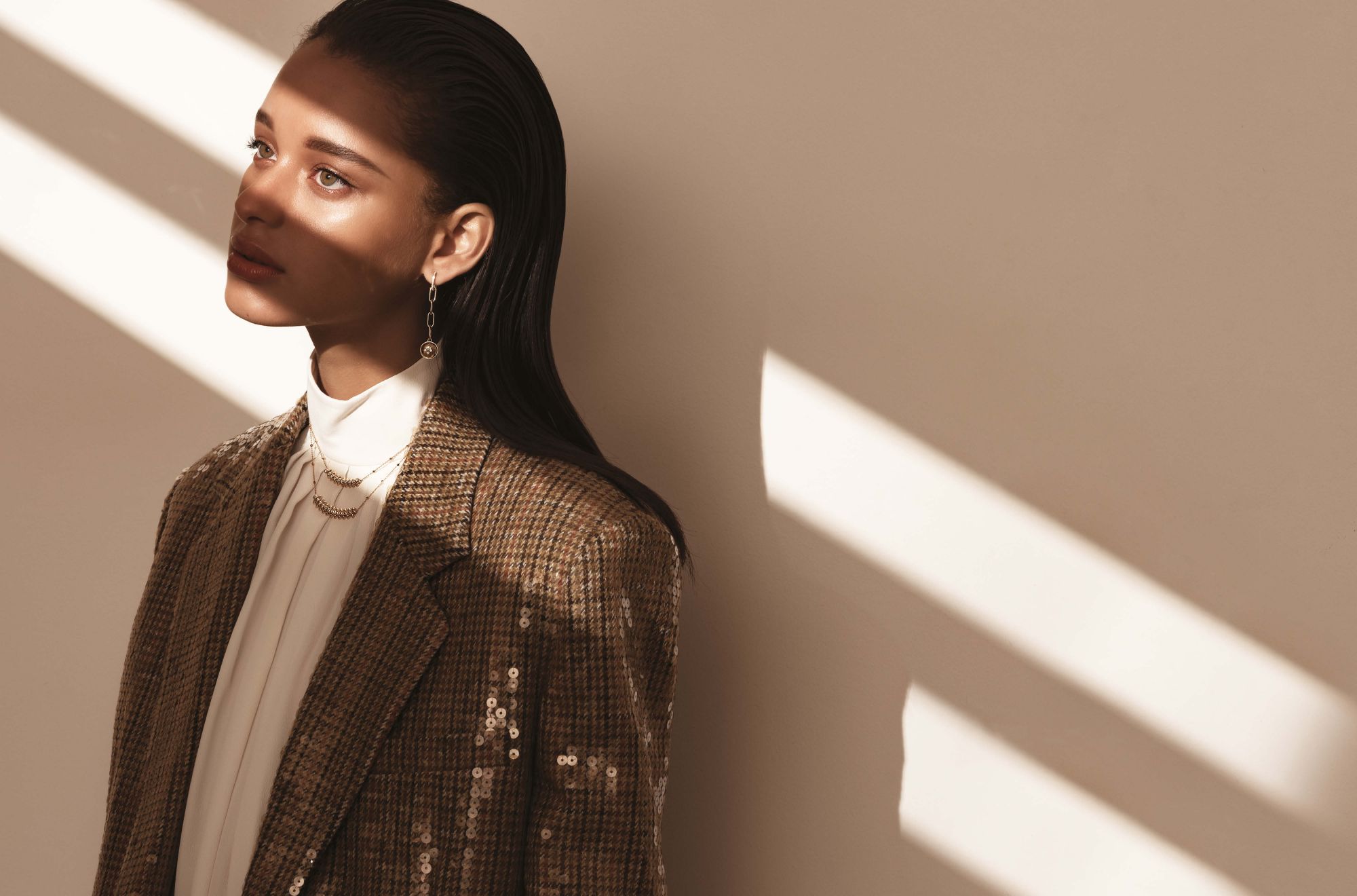 B Blossom earring in yellow and white gold set with diamonds, by Louis Vuitton; Clash de Cartier necklaces in pink gold set with diamonds, by Cartier; top and jacket by Celine
