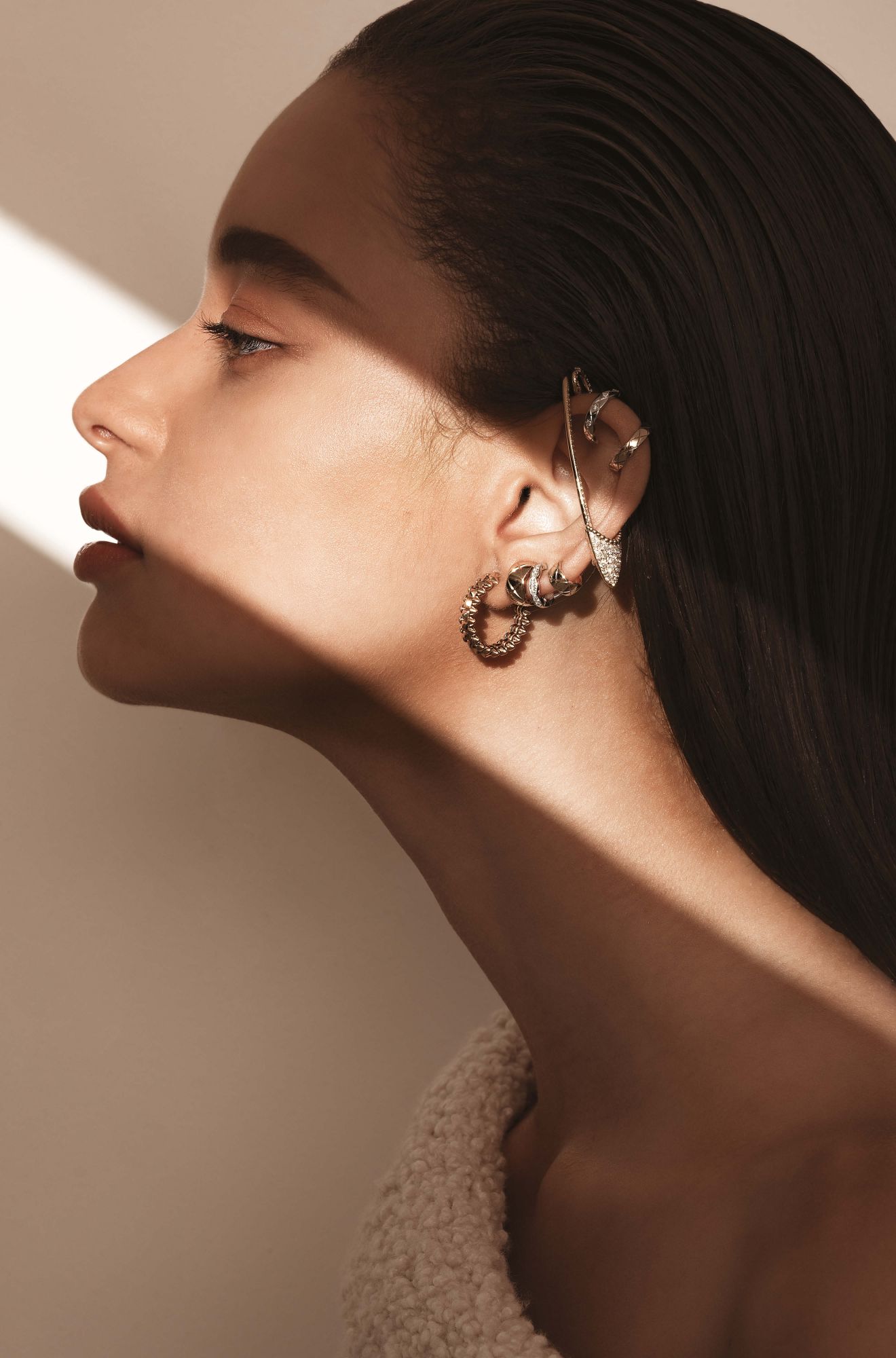 From top: Coco Crush ear cuffs in white and yellow gold, by Chanel; Serpent Bohème pin in yellow gold set with diamonds, by Boucheron; Coco Crush ear cuffs in white and yellow gold set with diamonds, by Chanel; Clash de Cartier earring in pink gold, by Cartier; top by 3.1 Phillip Lim