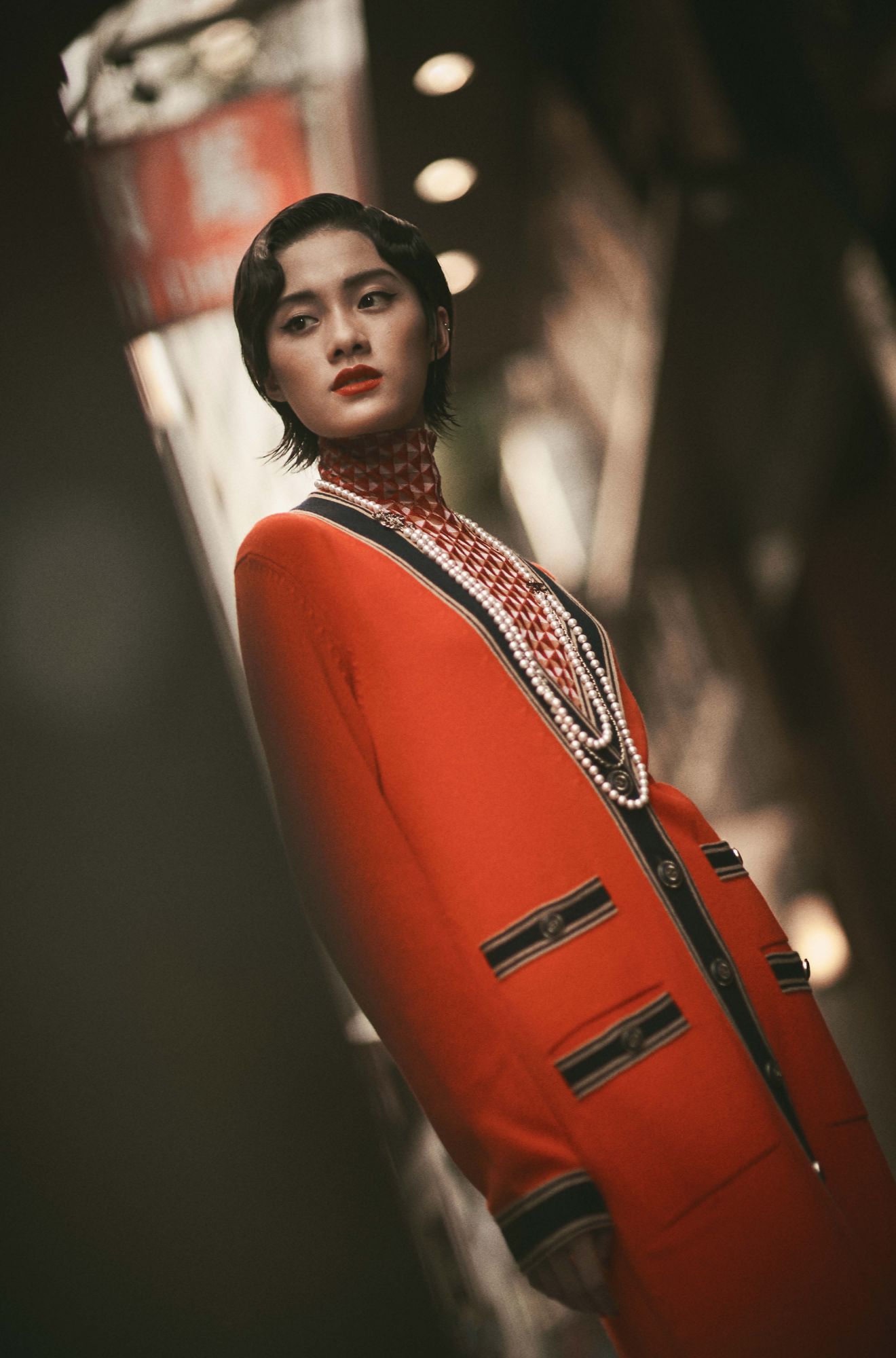 Le Si wears a top by Shiatzy Chen; and cardigan and necklaces by Chanel