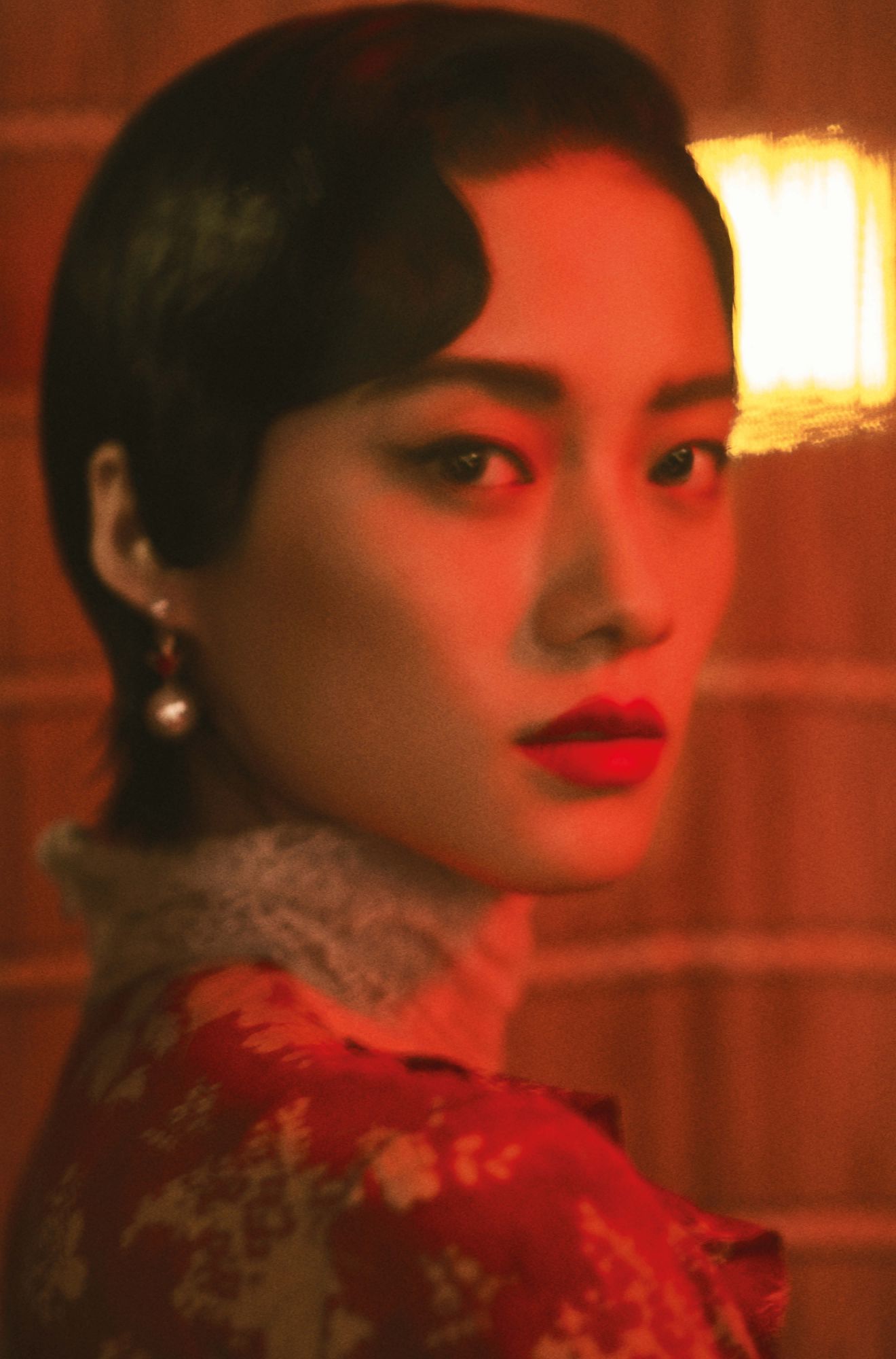 Le Si wears a dress by Valentino Red; and earrings by Christian Dior