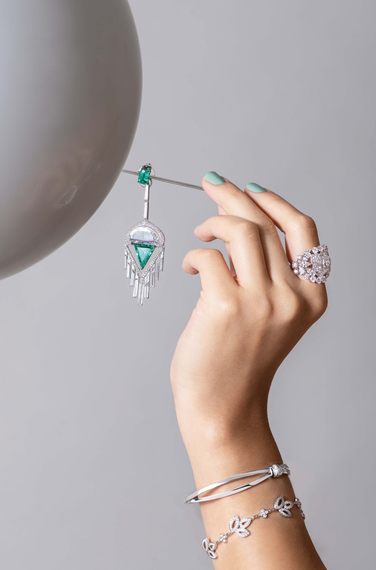 From top: Colombian No Oil Emerald and Diamond earring by Boghossian; Gem of Roses ring by Piaget; Liens Séduction bracelet by Chaumet; Lily Cluster bracelet by Harry Winston
