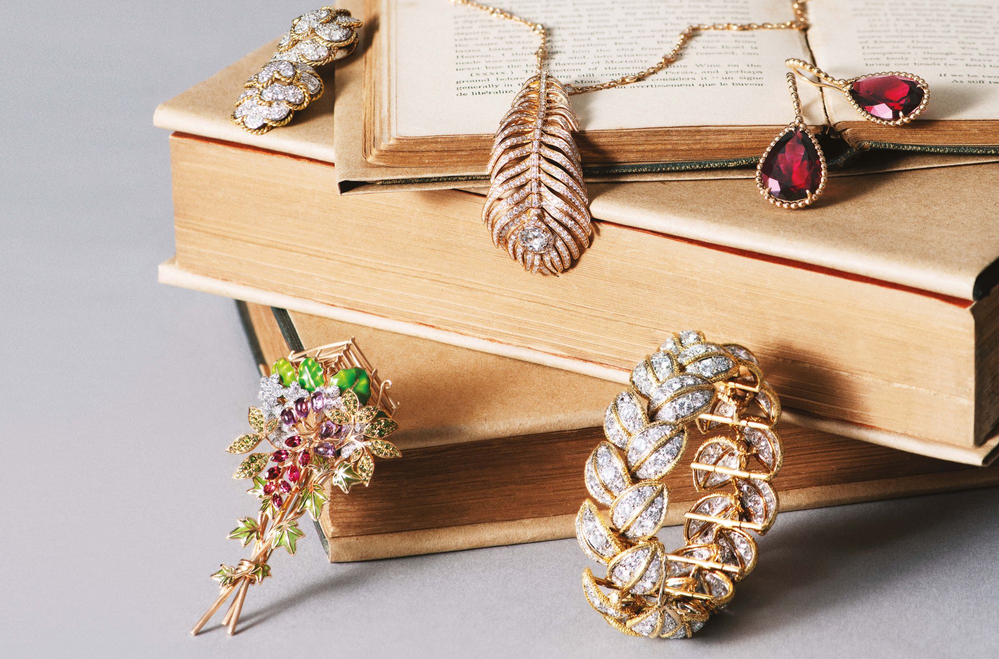 Clockwise, from top left: Heritage earrings, circa 1966, by Van Cleef & Arpels; Plume de Paon necklace and Serpent Bohème earrings by Boucheron; Primevère bracelet, circa 1967, by Van Cleef & Arpels; Cueillette brooch by Chaumet