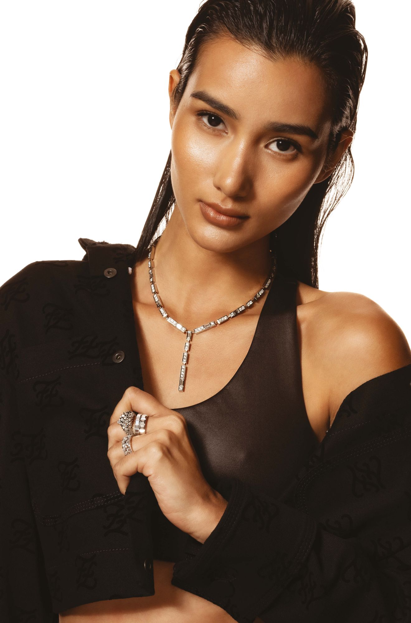 From top: Traffic necklace in platinum set with diamonds by Harry Winston; Hans, the Hedgehog ring in white gold set with sapphires and diamonds by Boucheron; Ice Cube ring in white gold by Chopard; Quatre Clou de Paris ring in white gold by Boucheron; My Dior ring in white gold set with diamonds by Dior Joaillerie. Jacket by Fendi; bra by Koral at Net-A-Porter