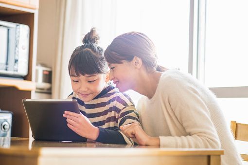 Girl using a digital tablet in home