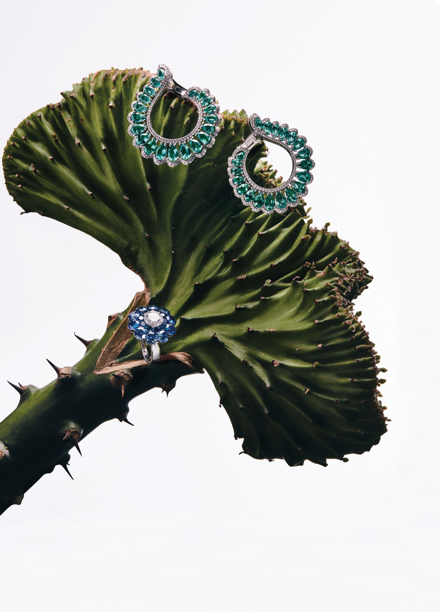 Earrings in white gold set with emeralds and diamonds; ring in white gold set with sapphires and a diamond, both by Chopard