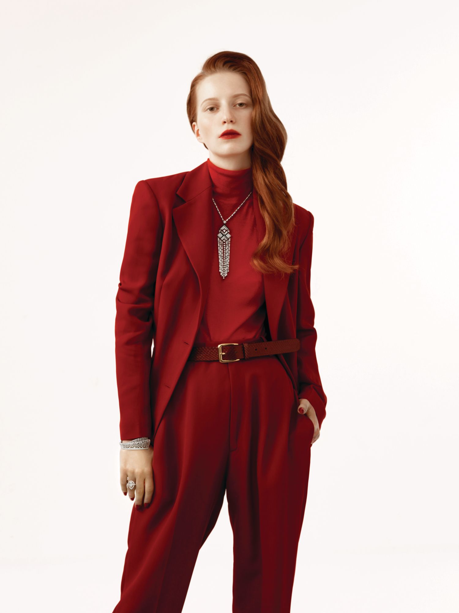 Charleston necklace in white gold set with onyx and diamonds by Chanel; Libre Plumetis bracelet in white gold set with diamonds by Dior Joaillerie; ring in white gold set with diamonds by Chopard. Suit by St John; top by Ninety Percent + Net Sustain, available at Net-a-Porter