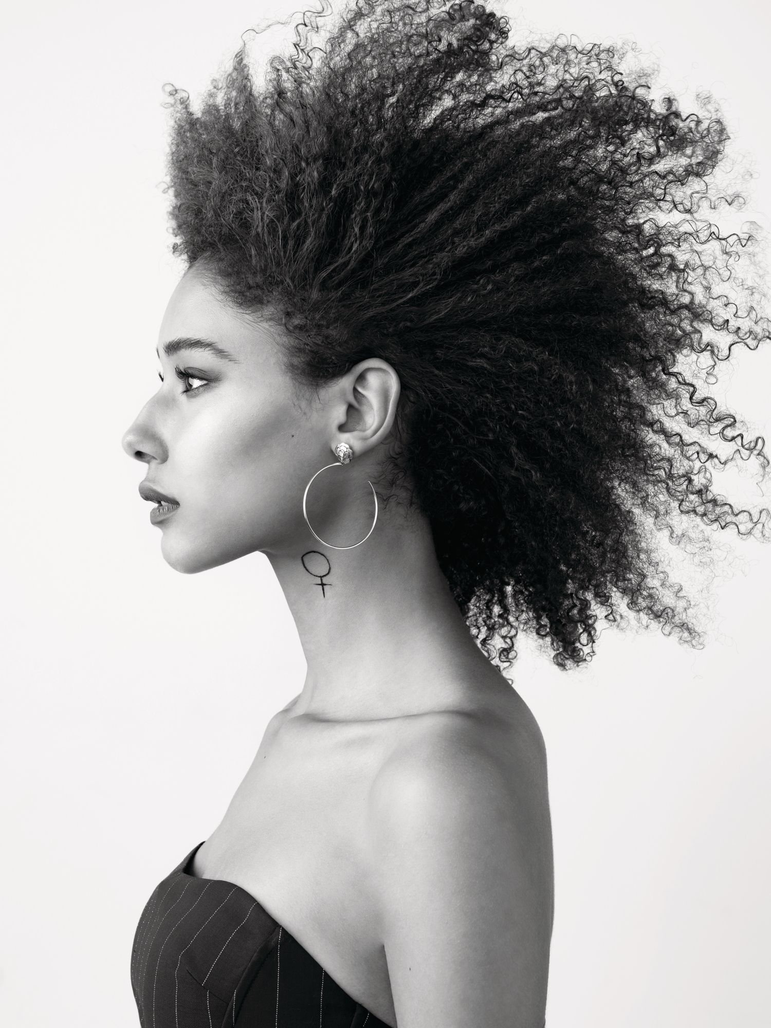 Chanel extrait de Camélia earring in pink gold set with diamonds. Model wears Ralph Lauren top.