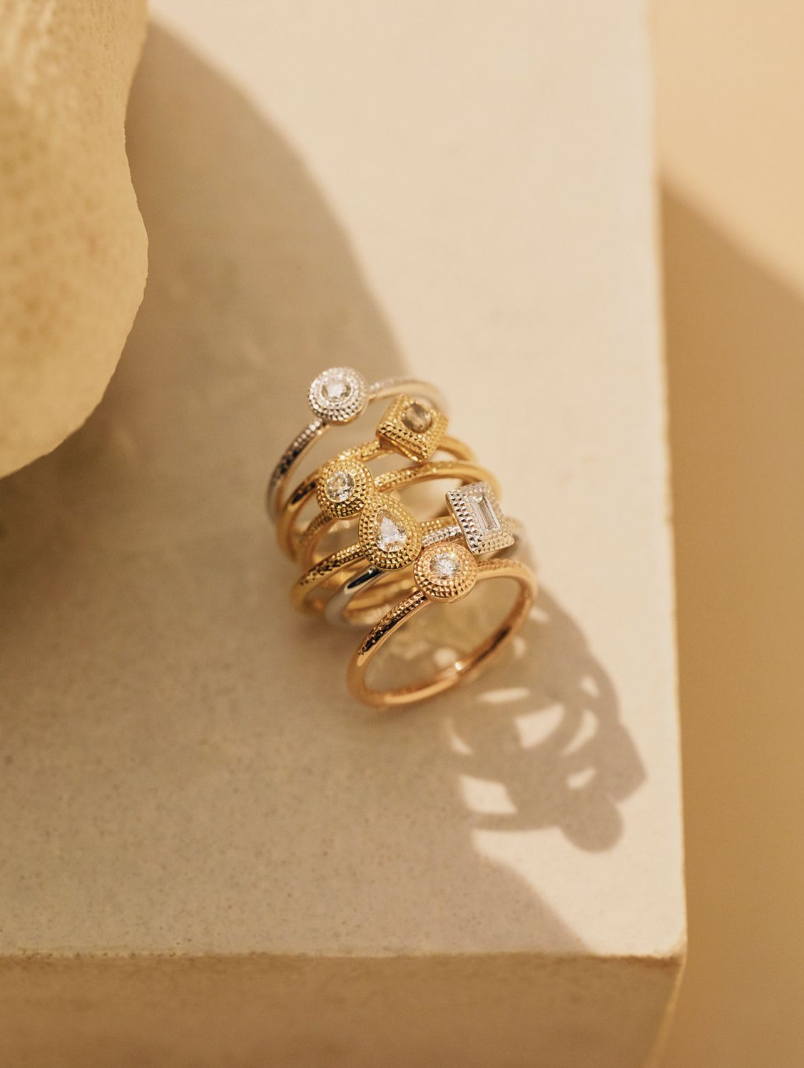 De Beers talisman rings in yellow, rose and white gold set with diamonds.