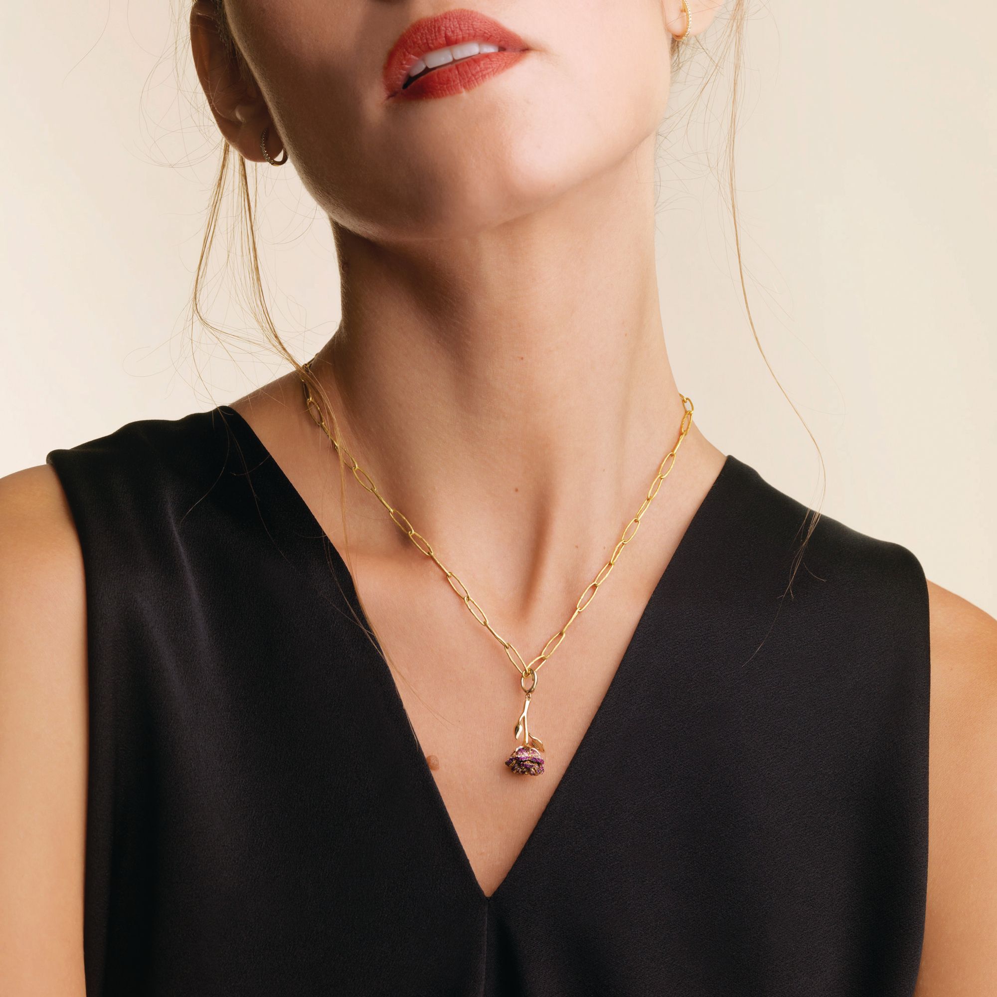 Annoushka Wild Rose Charm necklace in yellow gold set with rubies and sapphires.
