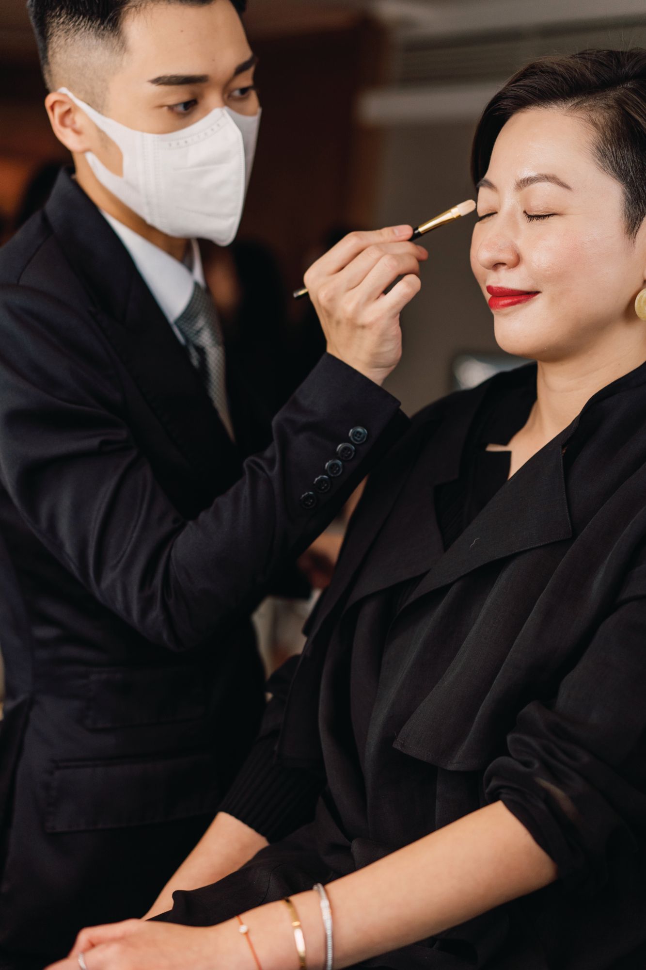 Leslie Tsang has her make-up applied by a pro
