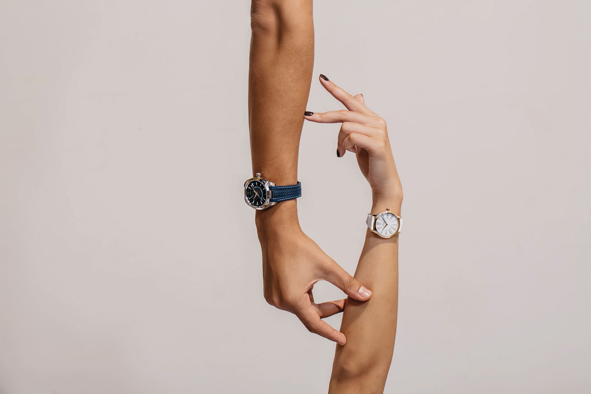 On him: Seamaster Aqua Terra Worldtimer. On her: De Ville Tresor, both by Omega