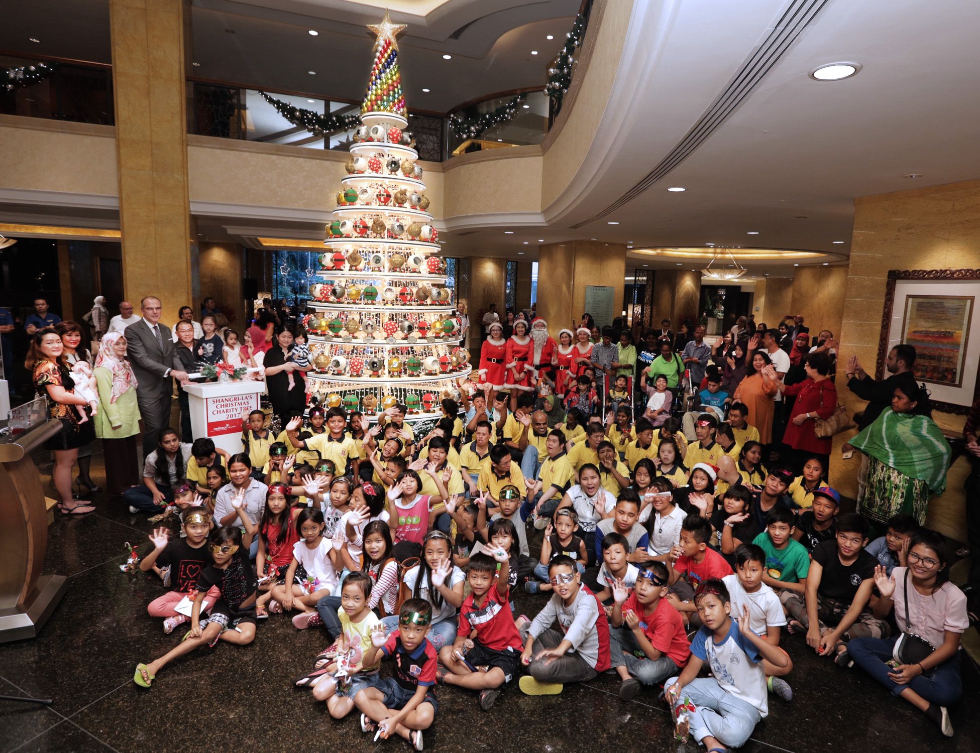 Manfred Weber - standing fourth from left - area general manager of Shangri-La Hotel Kuala Lumpur, lighted up ‘The Glittering Baubles of Life’ Christmas tree
