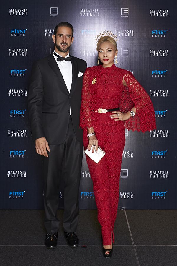 2015 October: A golden halo headpiece adds a regal touch to Esha Geneid's red lace jumpsuit at the Tatler Ball