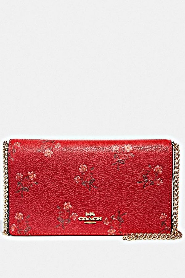 A classy red clutch like this one by Coach is a standout essential in every woman's collection (Photo credit: Coach)