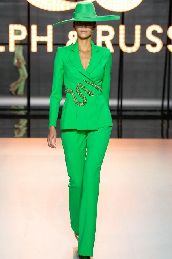 An elaborate snake belt cinches the waist of a green suit creating a reptilian vibe (Photo credit: Ralph & Russo)