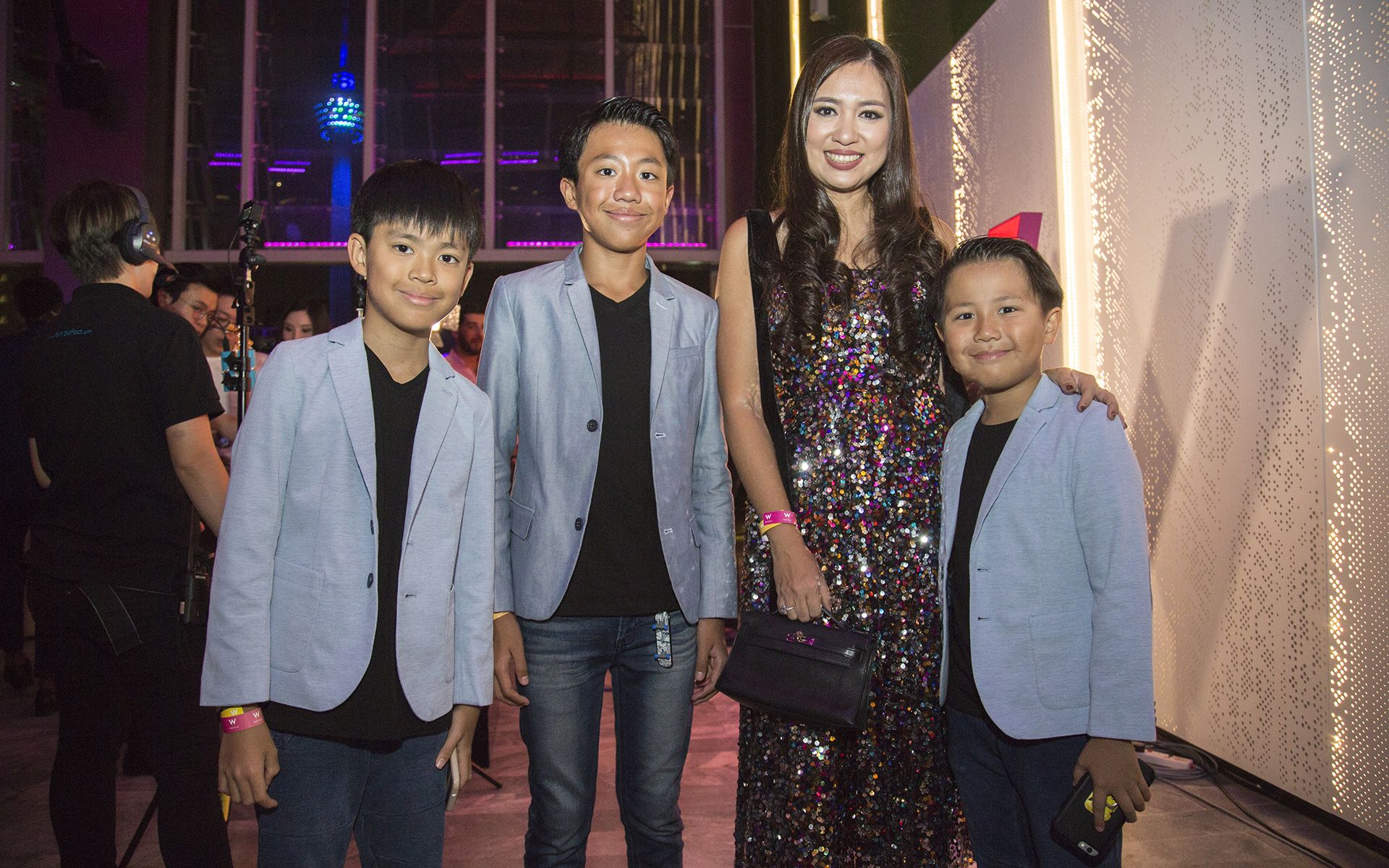 2018, August: As a nod to the party vibe at the grand launch of W Kuala Lumpur, Datin Yvette dons a rainbow sequinned dress, pictured with sons Marc, Matthew and Max, all adorably dressed in matching suits