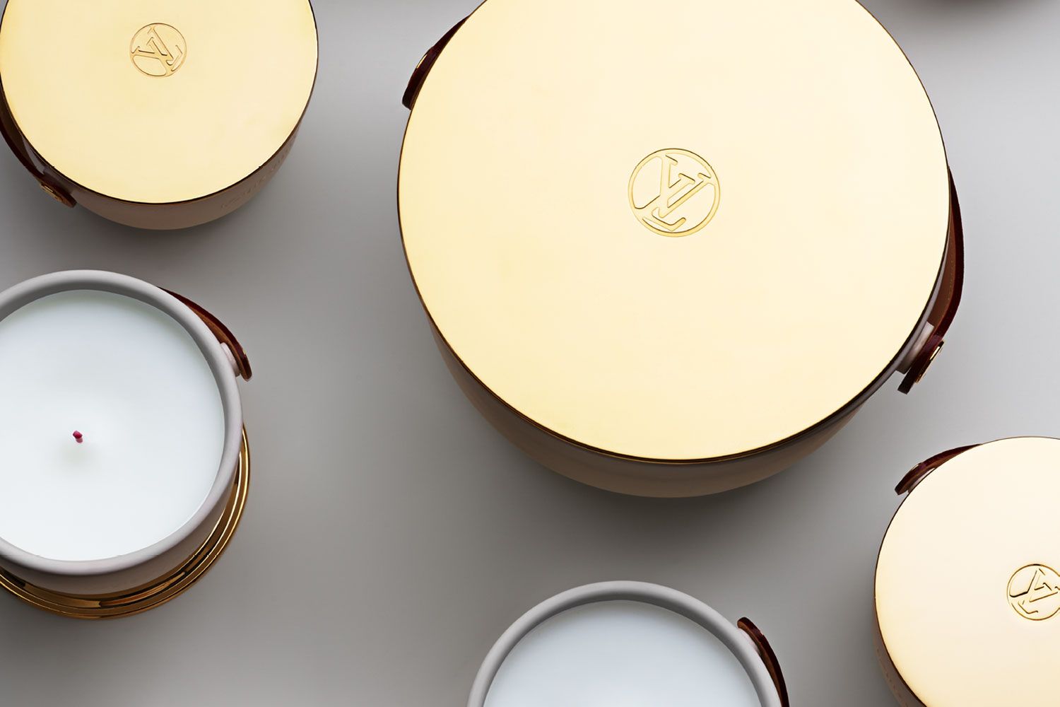 Introducing the deluxe edition of Louis Vuitton's L'Air du Jardin, Ile Blanche, Feuilles d'Or and Dehors Il Neige scented candles. (Photo: Courtesy of Louis Vuitton)
