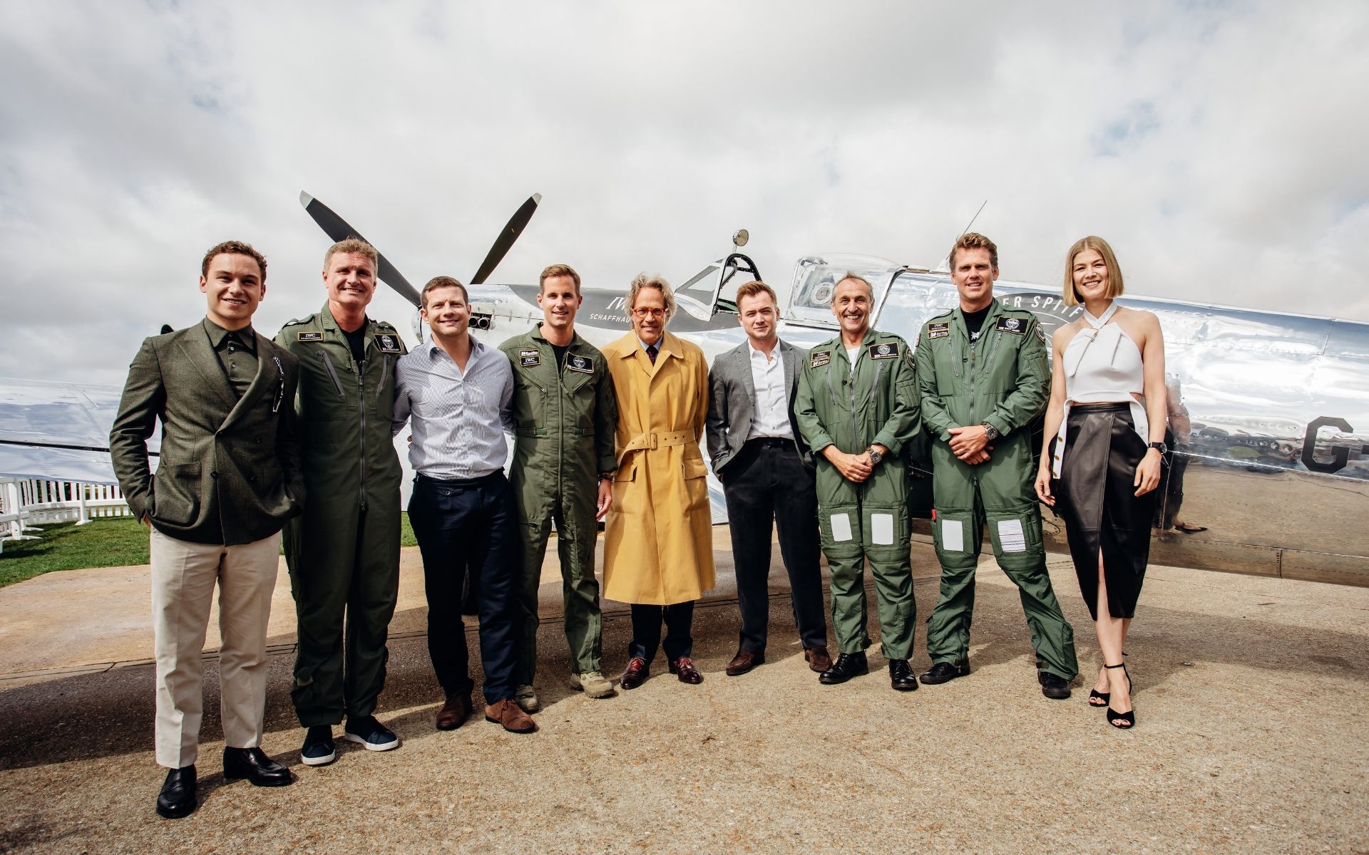 A group shot in front of the Silver Spitfire: Finn Cole, David Coulthard, Dermont O'Leary, Christoph Grainger-Herr, the Duke of Richmond, Taron Egerton, Steve Boultbee Brooks, Matt Jones and Rosamund Pike