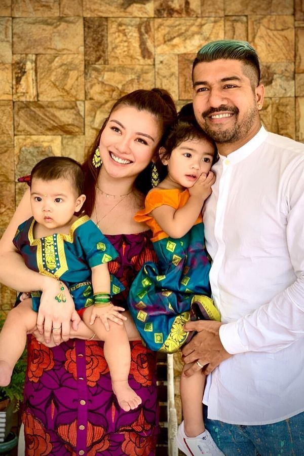 We can't tell which is brighter - those Diwali outfits or the smiles on Roen's and Carey's faces as they hold all they need in the palms of their hands. (Photo: @roencian/Instagram)