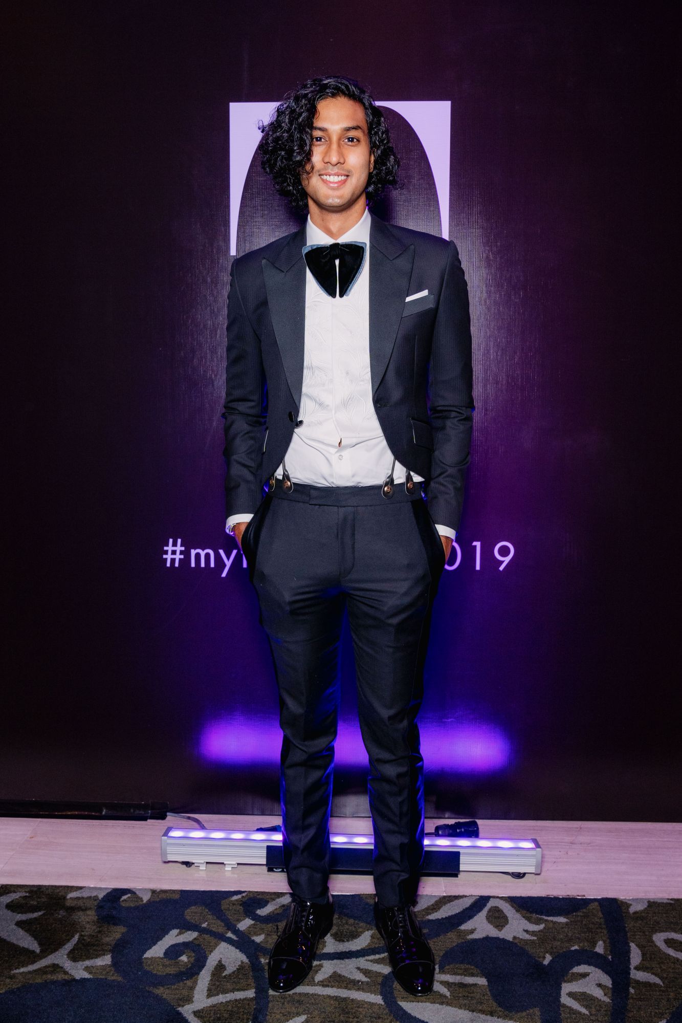 Like father, like son: Trunan Chandran rocked the embroidered suit with a butterfly bow-tie