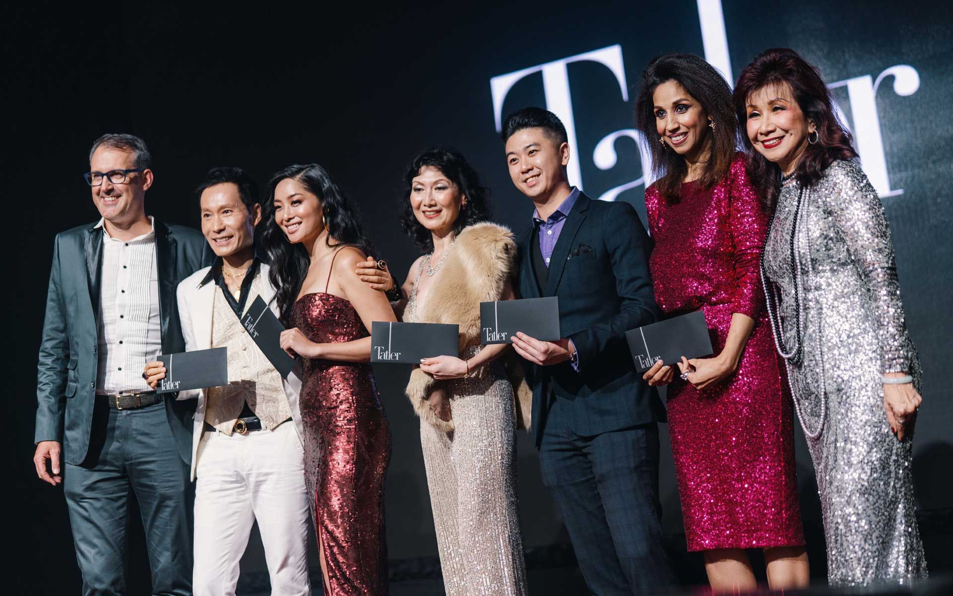 Michael Jopp (far left) and Florence Fang on stage presenting the Tatler Malaysia x Mercedes-Benz Malaysia Instagram contest winners with their prizes.