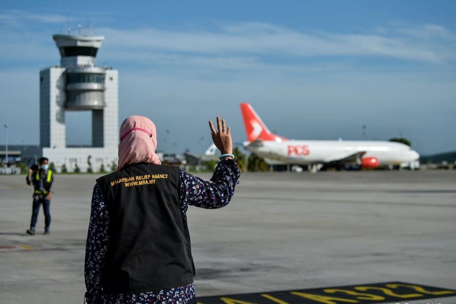 A Malaysian Relief Agency (MRA) member looks on at a plane holding supplies bound for Sabah at KLIA. (Photo: Courtesy of Fuad Nizam)