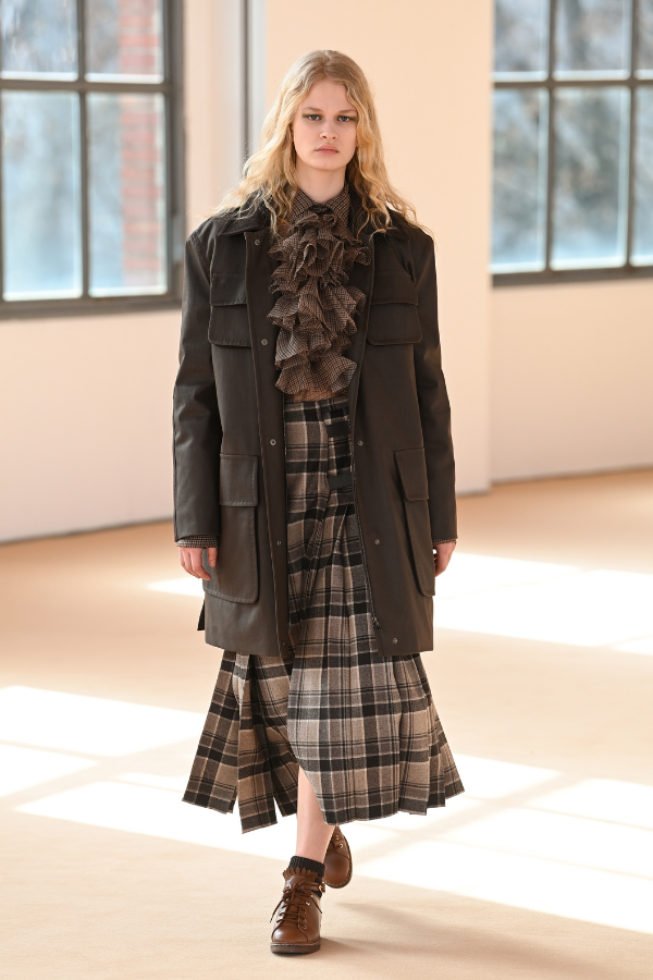 A structured long coat balances out the ruffles and pleats in this look