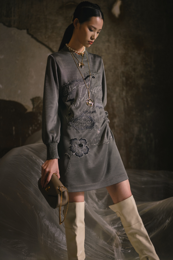 This minimalist piece employs delicate embroidery, updated to contemporary style
