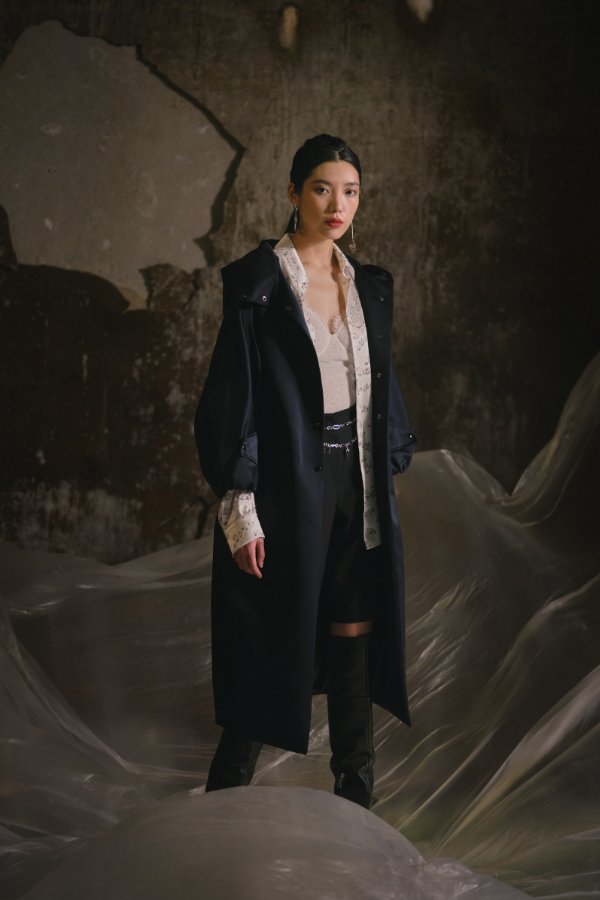 Impeccable styling: The oversized coat drapes over a youthful ensemble