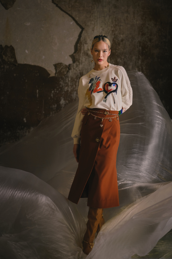 The waist chain belt and asymmetrical earrings complete this youthful, warm-hued look