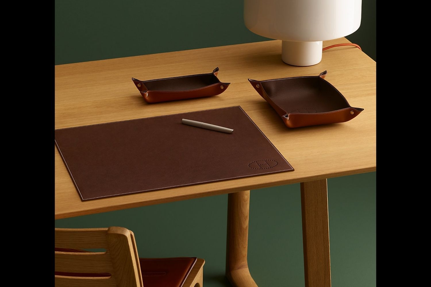 Kick writer's block to the curb with these gorgeous leather desk accessories from Hermēs' Mises et Relances line, from desk blotters to matching change trays and card cases (Photo: Hermēs)