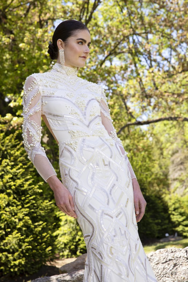 The beaded crystal and pearl detailing bring glamor to this figure-hugging silhouette with an open back