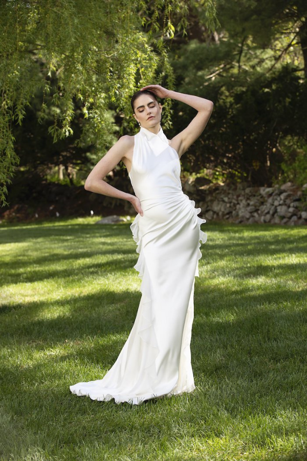 A high-neck draped asymmetrical satin gown