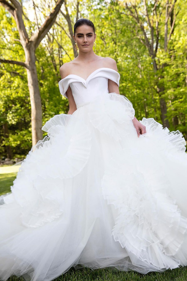The organza and tulle rosettes perfectly complement the sculpted, Bardot neckline