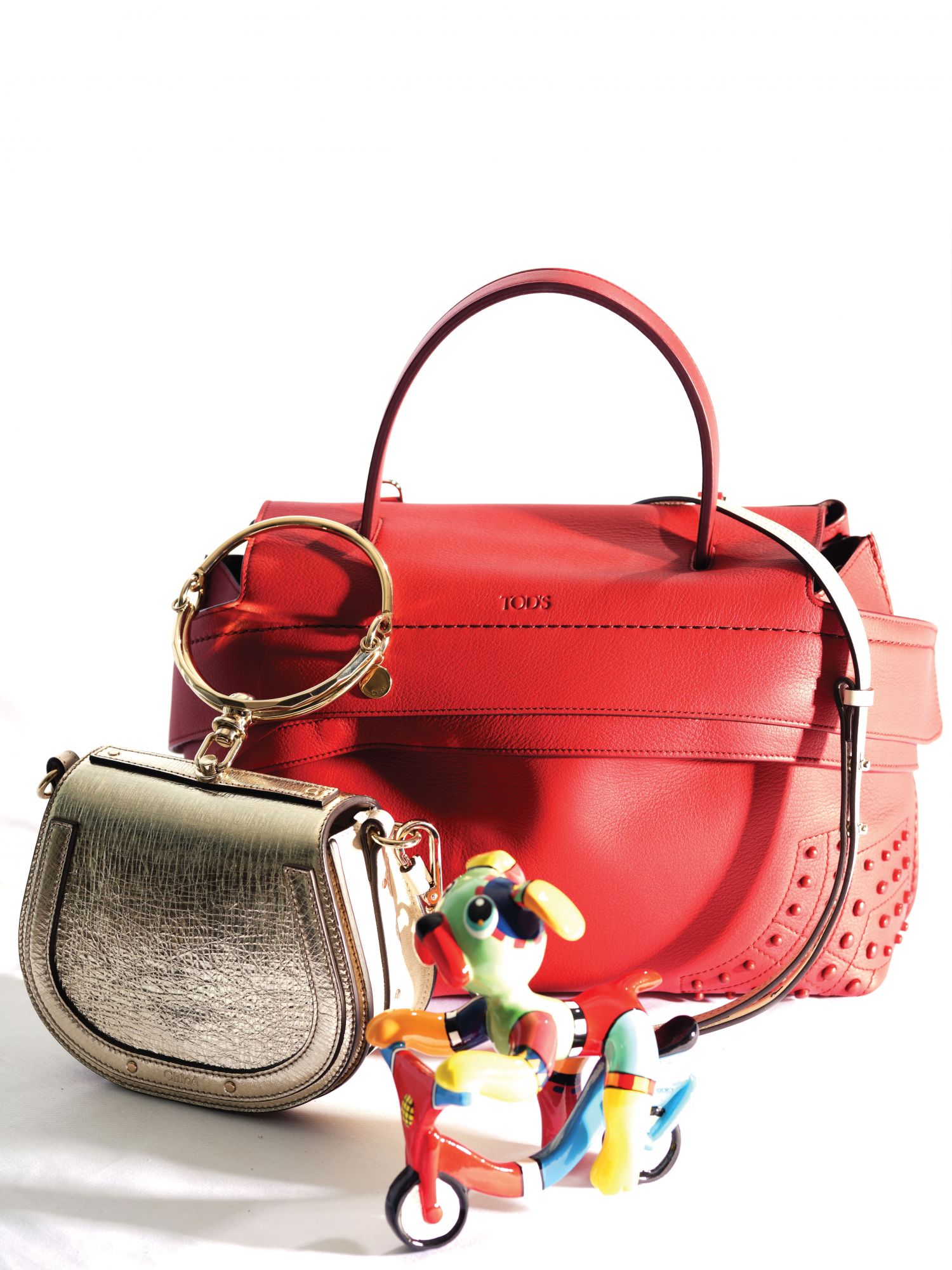 Tod’s Wave leather bag, Chloe mini Nile bracelet bag, and george small biking bulldog