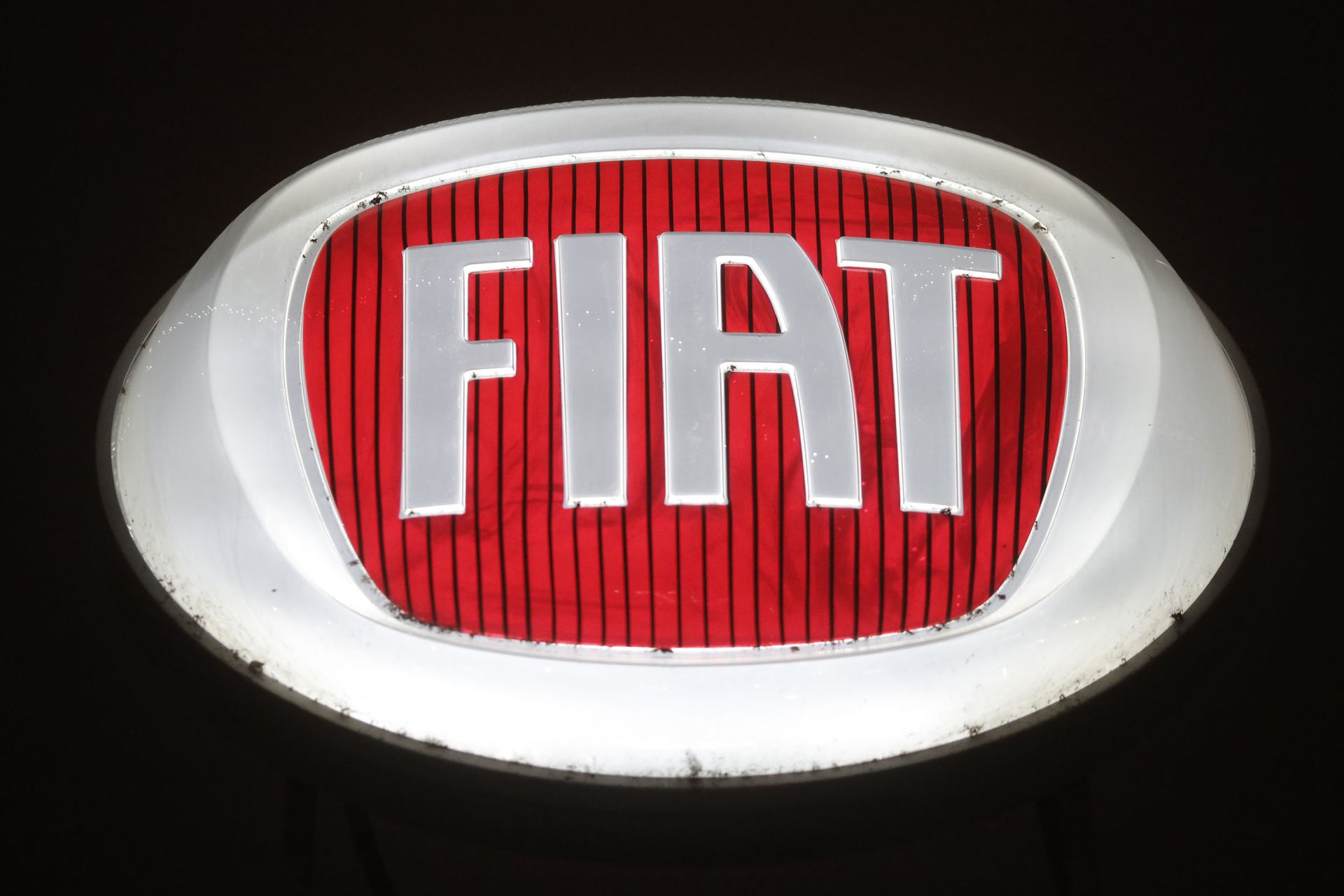 A picture shows the logo of Italian auto maker Fiat in a cars dealer on January 12, 2017 in Saluzzo, near Turin. The United States on January 12, 2017 charged Fiat Chrysler with using software on its trucks to evade emissions standards on about 104,000 vehicles, an accusation the company immediately denied. The Environmental Protection Agency said the undisclosed software on the 2014 to 2016 models of Jeep Grand Cherokees and Dodge Ram 1500 trucks sold in the United States allowed the vehicles to emit more