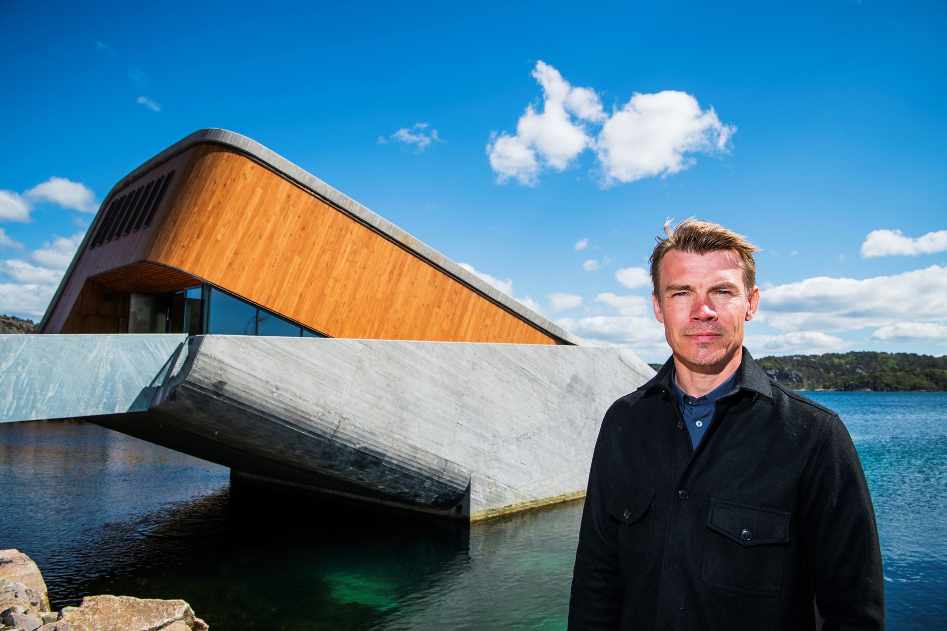 Photo taken on May 2, 2019, co-owner Stig Ubostad poses in front of Under, a restaurant that is semi-submerged beneath the waters of the North Sea in Lindesnes near Kristiansand, some 400 km south west of Oslo.