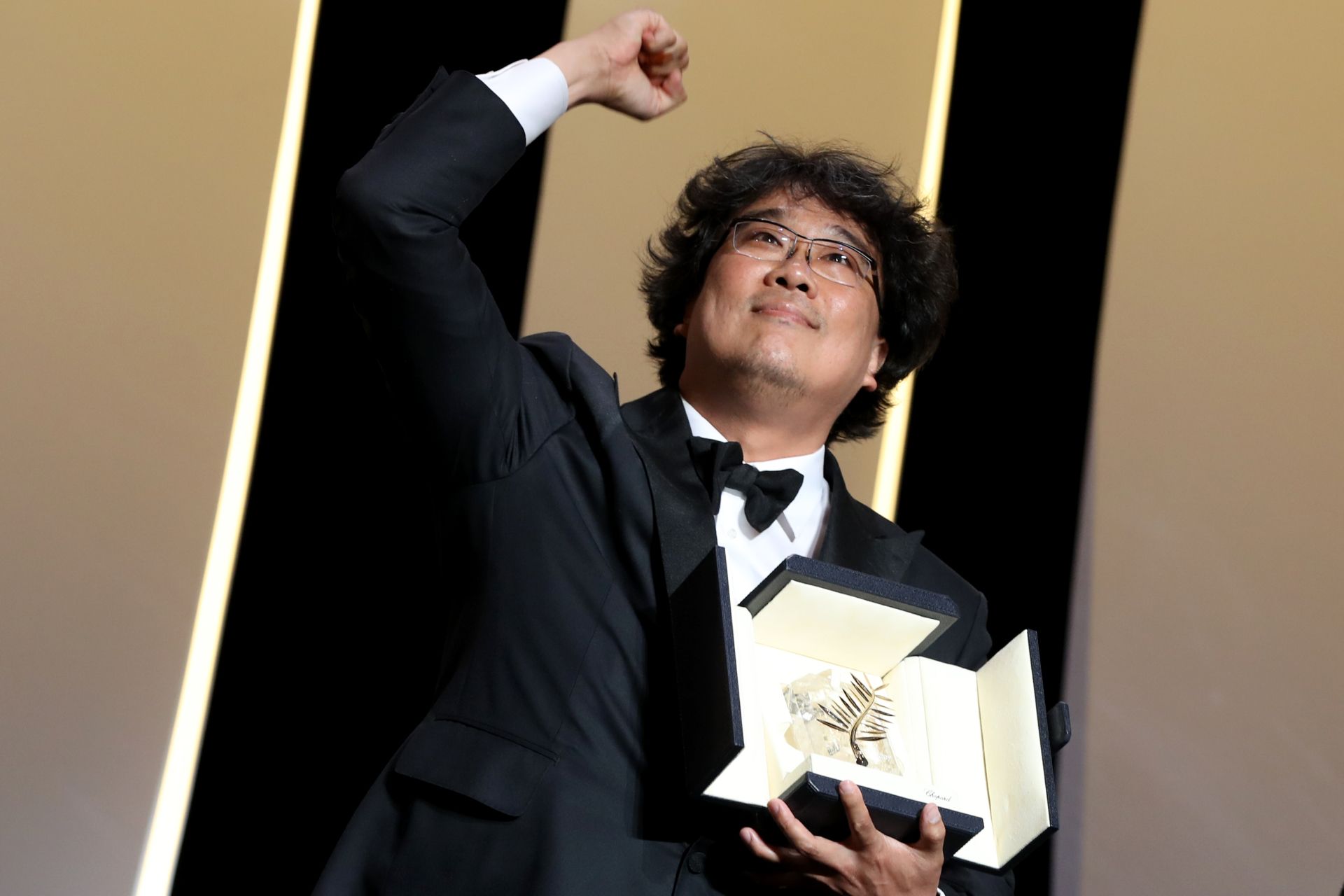 South Korean director Bong Joon-Ho poses on stage with his trophy after he was awarded with the Palme d'Or for the film "Parasite (Gisaengchung)" on May 25, 2019 during the closing ceremony of the 72nd edition of the Cannes Film Festival in Cannes, southern France. (Photo by Valery HACHE / AFP)