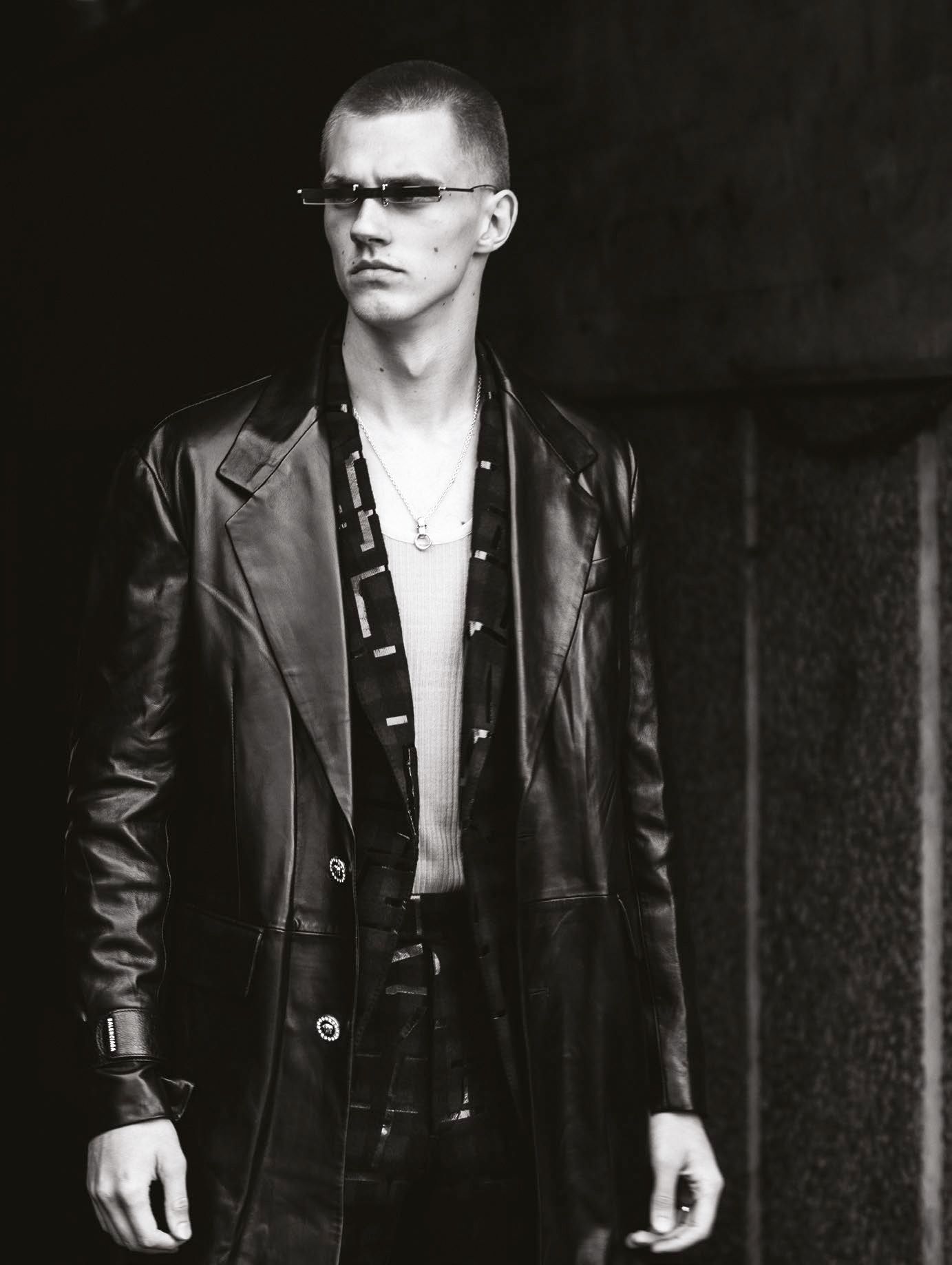 Coat by Versace, jacket by Ermenegildo Zegna, vest by Daniel W Fletcher, necklace by APC, available at Matches Fashion, sunglasses by Gentle Monster
