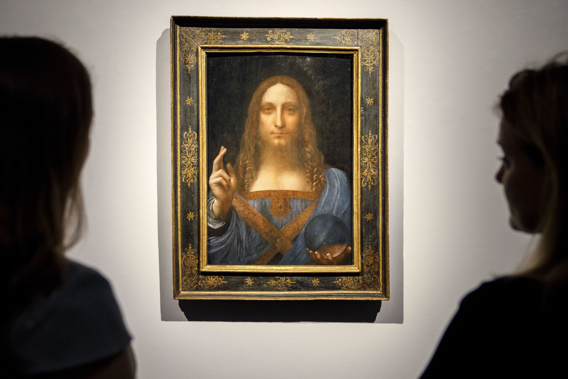 In this file photo taken on October 24, 2017 Christie's employees pose in front of a painting entitled Salvator Mundi by Italian polymath Leonardo da Vinci at a photocall at Christie's auction house in central London.The Louvre Abu Dhabi said on June 27, 2018 it will unveil its most prized acquisition to date, a Leonardo da Vinci painting that sold for nearly half a billion dollars at auction, on September 18. The 500-year-old "Salvator Mundi" painting depicting Jesus Christ, believed to be the wor