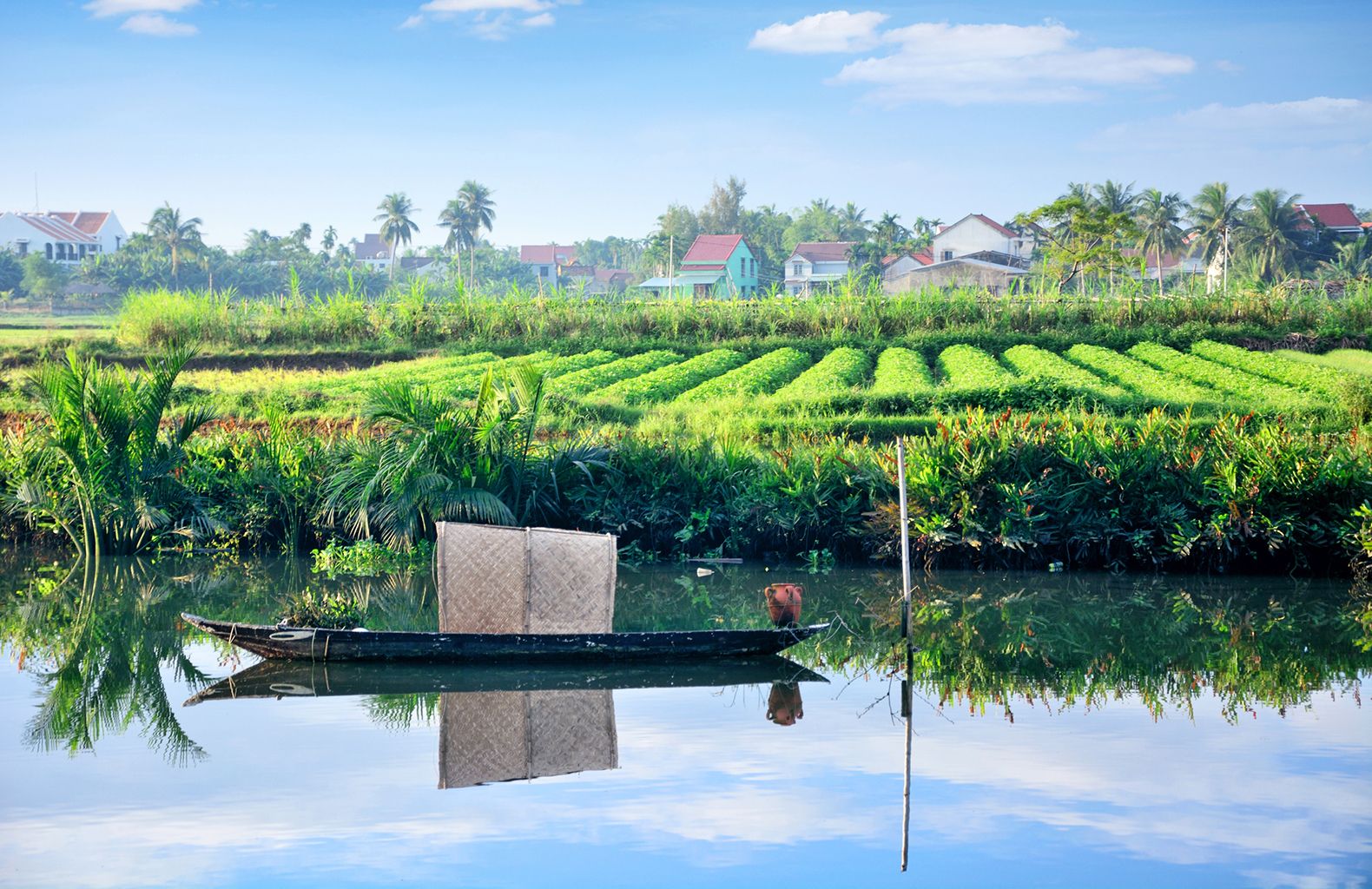 Rural landscape and small boat in Vietnam village. Composite photo